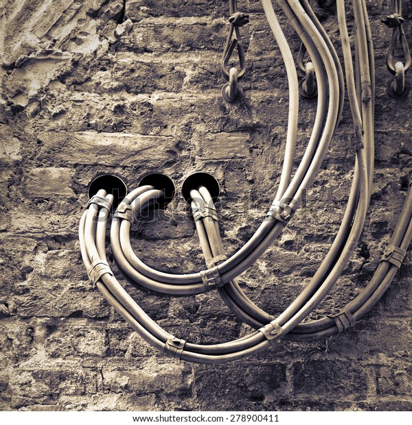 Electrical cables fixed on the wall for the distribution of electricity
