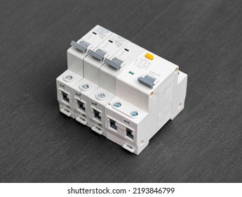 Electrical Circuit Breakers On A Gray Background, Close-up. Designed For Switching Electrical Circuits And Their Protection. Electromagnetic Short Circuit