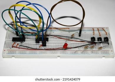 Electrical circuit built on a breadboard. It is a circuit built on breadboard using led, resistor, integrated circuit, button switch, jumper cable and wire. it simply shows what the breadboard is for.