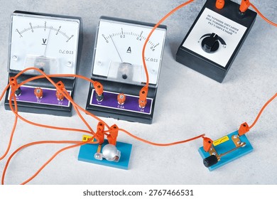 an electrical circuit consisting of a light bulb, an ammeter, voltmetr, a key and a current source