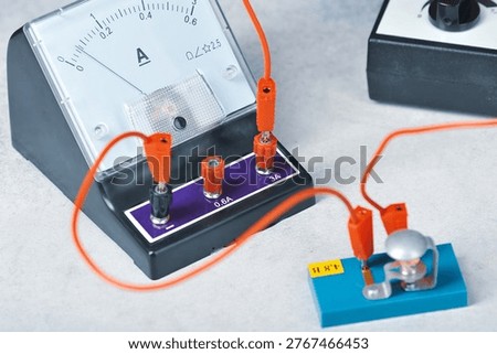 an electrical circuit consisting of a light bulb, an ammeter, a key and a current source