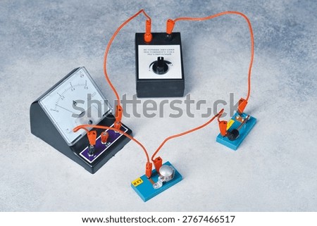 an electrical circuit consisting of a light bulb, an ammeter, a key and a current source
