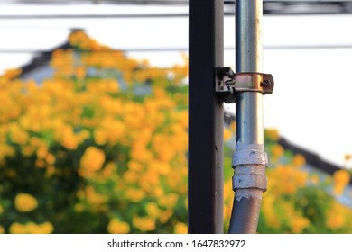 Electrical conduit for cable routing between electrical distribution panel with Pipe holder install outside the building.