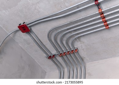 Electrical conduit for cable routing between electrical distribution panel with equipment at bottom of upper floor. Selective focus at junction box.