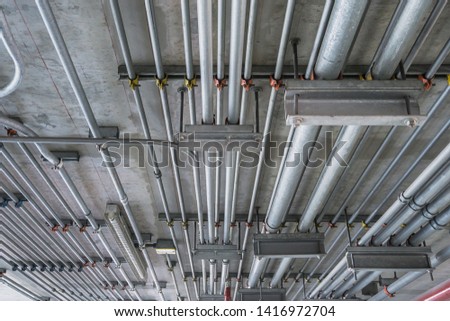 Electrical conduit for cable routing between electrical distribution panel with equipment at bottom of upper floor. Selective focus.