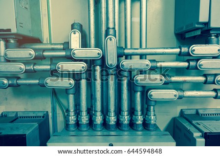 Electrical Conduit connected to junction box for connect electrical cable in box, with vintage tone for industrial technology concept