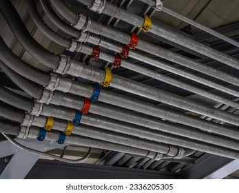 Electrical conduit system and tube of electric cable installed on building ceiling. Industrial infrastructure. Efficient electrical wiring installation and management. Wiring and conduit system.