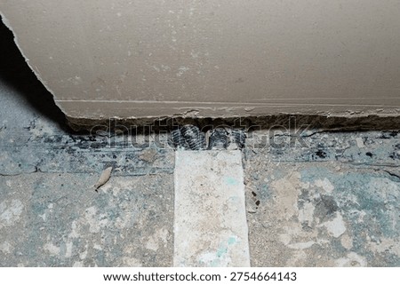 Electrical conduits and cables are embedded in the floor during renovation work