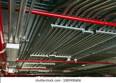 Electrical conduits system and metal pipeline installed on building ceiling.