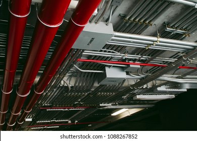 Electrical conduits system and metal pipeline installed on building ceiling.