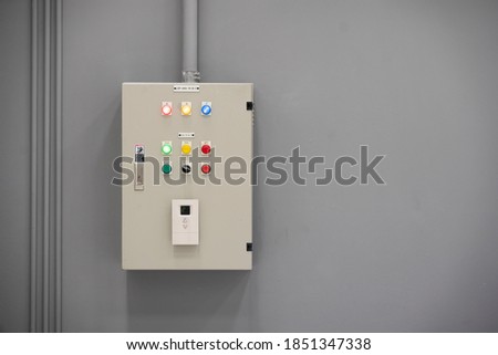 Electrical control cabinet on gray wall