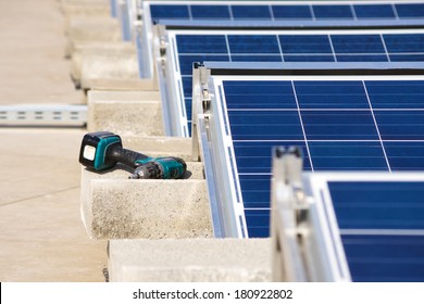 Electrical Drill Or Borer By The Solar Panel Flat Roof Construction 