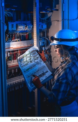 Electrical engineer analyzing power system diagram near switchboard. Technical inspection.
