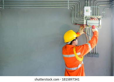Electrical engineer or electrician male Asian worker Perform testing and installation of electrical switches and sockets in homes and buildings.