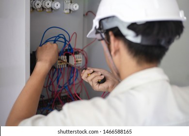 Electrical Engineer Holding Safety Helmet Front Electrician Working On Electric Power Pole.