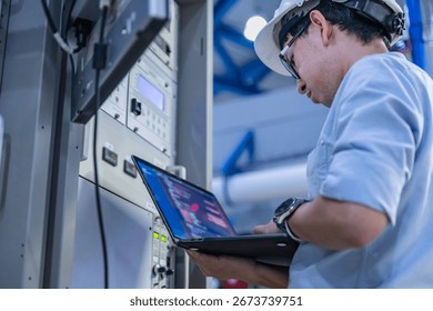 Electrical engineer male checking voltage at the Power Distribution Cabinet in the control room,preventive maintenance Yearly,inspecting power system and control panel in industrial factory - Powered by Shutterstock - Get 15% off with code: PIKWIZARD15