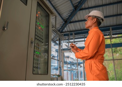 Electrical engineer man checking voltage at the Power Distribution Cabinet,preventive maintenance Yearly,Supervisor Working at a wastewater treatment plant