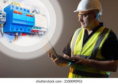 Electrical Engineer. Portrait Of Engineer Next To Electric Machines. Fragment Of Shield For Controlling Electricity. Electrician With Laptop In His Hands. Smart Home Customization Concept.