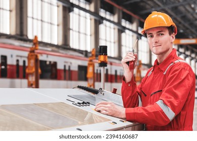 Electrical engineer railway checking construction process electric train and maintenance station .Engineer wearing safety uniform and helmet by using walki-talkie in work. transportation, transport.