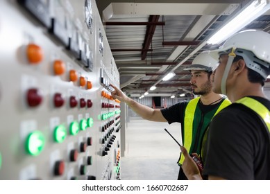 Electrical Engineer team working front HVAC control panels, Technician daily check controls system for security functions in service room at factory. Heating,Ventilation,Air Conditioning.