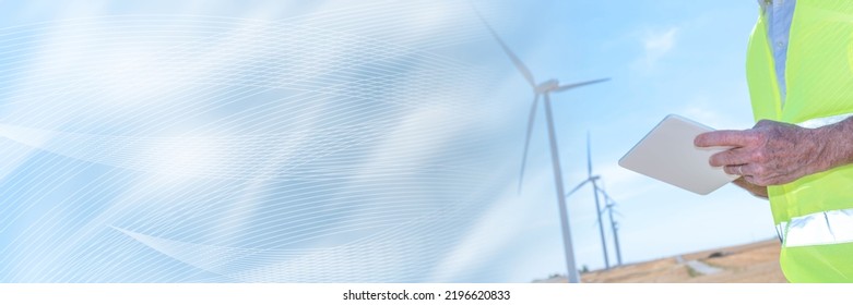 Electrical engineer using digital tablet for wind turbine inspection; panoramic banner
