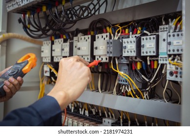 Electrical engineer using measuring equipment to checking electric current voltage at circuit breaker and cable wiring system , Electrical service concept . - Shutterstock ID 2181974231