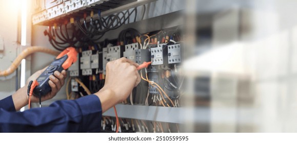 Electrical engineer using measuring equipment to checking electric current voltage at circuit breaker and cable wiring system , Electrical service concept .	
