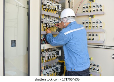 Electrical Engineer Wiring Electric Cable Supply And Switch Board In The Control Panel Board At The Factory