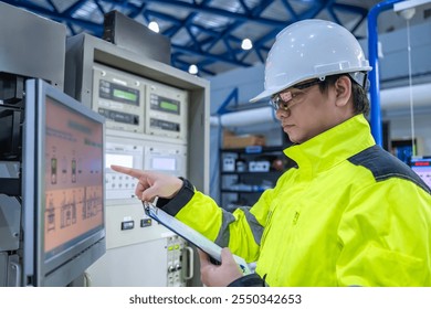Electrical engineer woman checking voltage at the Power Distribution Cabinet in the control room,preventive maintenance Yearly,Thailand Electrician working at company