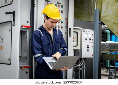 Electrical engineer working in control room. Electrical engineer man checking Power Distribution Cabinet in the control room