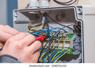 Electrical engineer working with power connection - wires, close-up - Shutterstock ID 2240721153