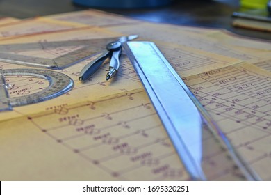 Electrical engineer workplace - electrotechnical project, rulers, and divider compass. Construction and electrotechnology concept. Engineering tools. Circuit diagram on background