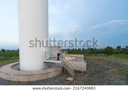 Electrical Engineering It is checking the operation of the wind turbines that are generating electricity on top of the hill.