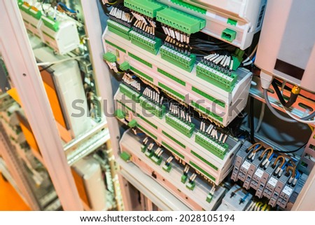 Electrical engineering concept. Electrical cabinet with many automatic machines. Electrical equipment close-up. Power control panel. Electrification equipment. Power switches with many wires.