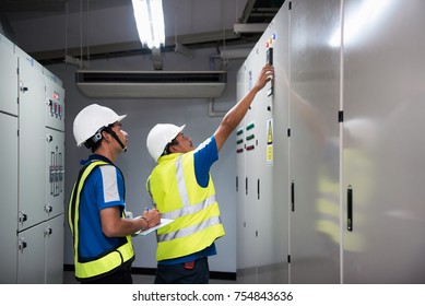 Electrical Engineering With Inspector While Training And Recording In Operation Of Power In The Plant For Production Process, Routine Daily Record. Focusing On Foreground People Learning Concept.