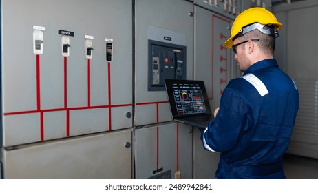 Electrical engineers and technicians work together to solve electrical system failures in industrial control rooms.supervisor maintains the circuit cabinet.