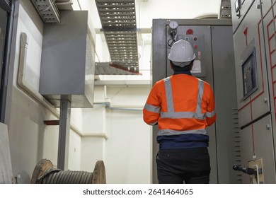 Electrical engineers and technicians work together to solve electrical system failures in industrial control rooms.supervisor maintains the circuit cabinet.