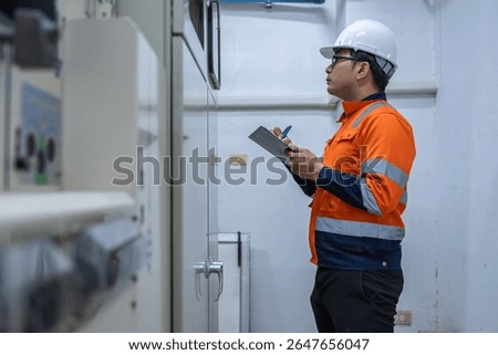 Electrical engineers and technicians work together to solve electrical system failures in industrial control rooms.supervisor maintains the circuit cabinet.