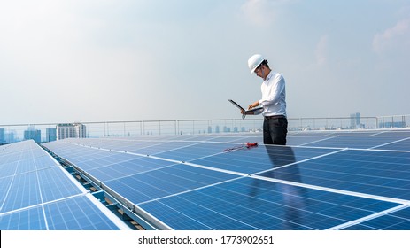 Electrical Engineers Are Using Laptops To Monitor The Operation Of The Solar Rooftop. Renewable Energy Concepts.