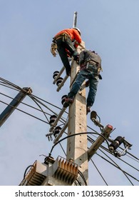 Electrical Engineers Working On Electricity Pylon High Tension Power Line Repairs And Maintenance 