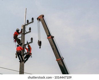 Electrical Engineers Working On Electricity Pylon High Tension Power Line Repairs And Maintenance 