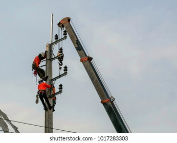 Electrical Engineers Working On Electricity Pylon High Tension Power Line Repairs And Maintenance