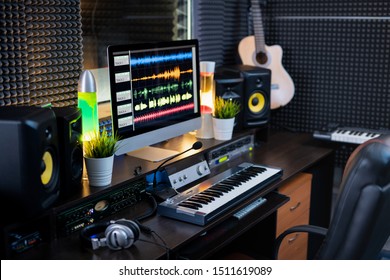 Electrical Equipment For Music Recording And Computer Monitor With Sound Mixing Tracks On Workplace Of Deejay Or Modern Musician In Studio