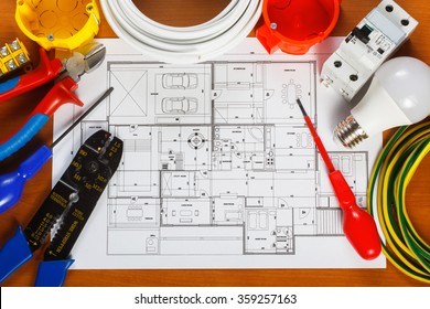 Electrical Equipment, Tools And House Plans On The Desk