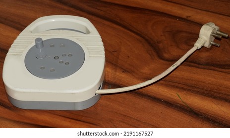 Electrical Extension Chord On A Wooden Surface 