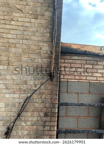 An electrical fire recently occurred here, as you can see the wires melted and then it caught to the wooden fence. Luckily the shed is not made of wood also