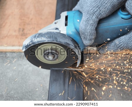 Electrical Grinder cutting square metal pipe