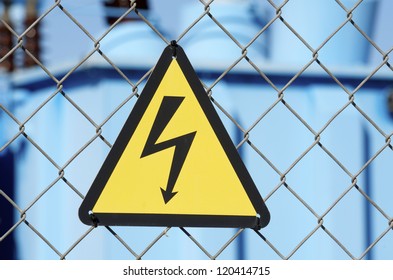 Electrical Hazard Sign Placed On A Metal Fence