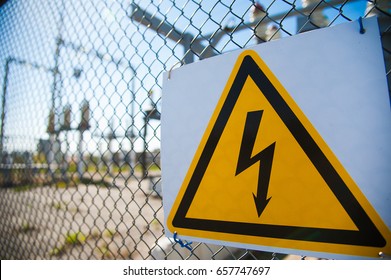 Electrical Hazard Sign Placed On A Metal Fence