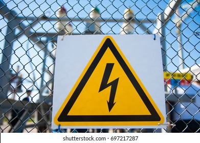 Electrical Hazard Sign Placed On A Metal Fence